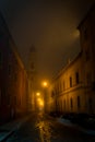 Narrow street in Parma at fuggy evening