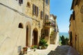 Narrow street of Pienza, a village located in the beautiful Tuscany valley, known as the `ideal city of the Renaissance` and a