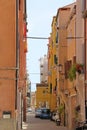 narrow street, small street in an Italian city, parked cars in a narrow passage between houses