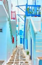 Narrow street with small whitewashed houses in Mykonos