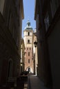 Narrow street and St. Martin church bell tower in Warsaw Old Town Royalty Free Stock Photo