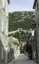 Narrow street in Ston with Great Wall in background in Ston, Croatia Royalty Free Stock Photo