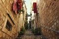 Narrow street with stone stairs and pots with flowers in Dubrovnik, Croatia Royalty Free Stock Photo