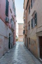 Narrow street with stone texture close buildings