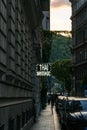 Narrow street at sunset in Budapest Hungary with neon sign Thai massage.