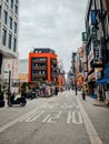 a narrow street is surrounded by buildings and people on motorcycles