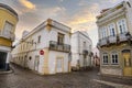 Narrow street with traditional fishermen`s houses in Olhao, Portugal