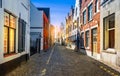 Narrow street with traditional houses in medieval city center of Bruges, Belgium. Royalty Free Stock Photo