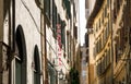 Narrow street with traditional italian trattoria, family restaurant sign. Healthy food place in Florence, Italy