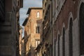 Narrow street with typical italian houses in Lucca, Tuscany