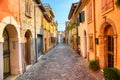 Narrow street of the village of fishermen San Guiliano with colorful houses and a bicycle in early morning in Rimini, Italy