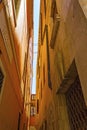 Narrow street yellow old buildings strip of sky Venice