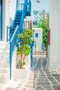 The narrow streets of the island with blue balconies, stairs and flowers. Royalty Free Stock Photo