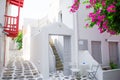 The narrow streets with blue balconies, stairs, white houses and flowers in beautiful village in Greece. Beautiful Royalty Free Stock Photo