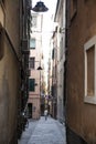 The narrow streets of the city of Genoa Italy. Old cobblestone road in the window grilles. Beautiful Perspective Lane. A good