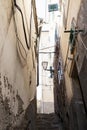 The narrow streets of the city of Genoa Italy. Old cobblestone road in the window grilles. Beautiful Perspective Lane. A good