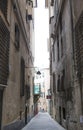 The narrow streets of the city of Genoa Italy. Old cobblestone road in the window grilles. Beautiful Perspective Lane. A good Royalty Free Stock Photo