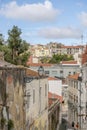 Narrow streets, clay roofs, trees and clouds in Lisbon, Portugal