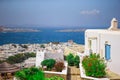 The narrow streets of greek island with blue balconies, stairs and flowers. Beautiful architecture building exterior Royalty Free Stock Photo