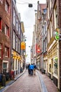 Narrow Streets with historic buildings in the center of the old city of Amsterdam Royalty Free Stock Photo