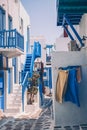 The narrow streets of the island with blue balconies, stairs and flowers. Royalty Free Stock Photo