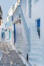 The narrow streets of the island with blue balconies, stairs and flowers. Mykonos, Greece. Royalty Free Stock Photo