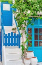 The narrow streets of the island with blue balconies, stairs and flowers. Mykonos, Greece. Royalty Free Stock Photo