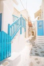 The narrow streets of the island with blue balconies, stairs and flowers. Royalty Free Stock Photo