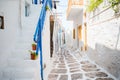 The narrow streets of the island with blue balconies, stairs and flowers. Royalty Free Stock Photo