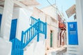 The narrow streets of the island with blue balconies, stairs and flowers. Royalty Free Stock Photo