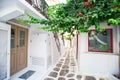 The narrow streets of the island with blue balconies, stairs and flowers in Greece. Beautiful architecture building Royalty Free Stock Photo