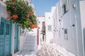 The narrow streets of the island with blue balconies, stairs and flowers. Royalty Free Stock Photo