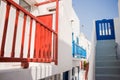 The narrow streets of the island with blue balconies, stairs and flowers. Royalty Free Stock Photo