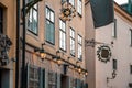 Narrow streets with New Year's, Christmas decorations, festive garlands and stars on the facades of old houses on the Royalty Free Stock Photo