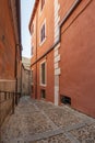 Narrow streets of the old city of Toledo with painted red walls Royalty Free Stock Photo