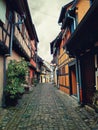 Narrow streets of the old Eguisheim with half-timbered medieval houses along the famous wine route in Alsace, France Royalty Free Stock Photo