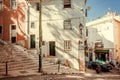 Narrow streets and stairs between stores and bars of the old sunny capital city