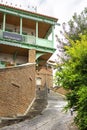 Narrow streets of Tbilisi old town with beautiful colorful wooden balconies and red brick houses