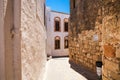 Narrow streets and typical Greek buildings in the city of Lindos.