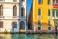 Narrow Venice street between two palaces on the bank of the Gran