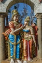 Narrow view of an ancient colorful sculpture of a men, seen talking with a women, Chennai, Tamil nadu, India, Jan 29 2017