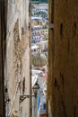 Narrow view of a Church dome through buildings in Italy