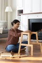 Narrow view of ethnic woman gather furniture Royalty Free Stock Photo