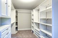 Narrow walk-in closet lined with built-in drawers Royalty Free Stock Photo