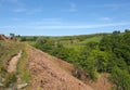 Narrow walking path on high moorland surrounded by pasture with stone walls above crimsworth dean valley in west yorkshire Royalty Free Stock Photo