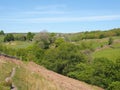 A narrow path on high moorland surrounded by pasture with stone walls above crimsworth dean valley in west yorkshire Royalty Free Stock Photo