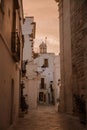 Narrow white street in Locorotondo during sunset, region Puglia, Italy