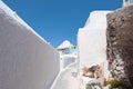 Narrow whitewashed street in Fira town on the Santorini (Thira) island in Greece.