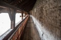 Narrow wooden corridor with rock wall in chateau de chillon the medieval castle in Montreux Royalty Free Stock Photo