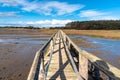 Narrow Wooden Footbridge over a Tidal Creek and Blue Sky